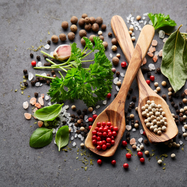 Spices and herbs on black board