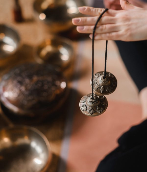 Close-up of a woman's hand holding Tibetan bells for sound therapy. Tibetan cymbals.